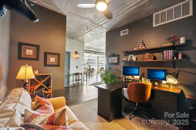 a bedroom with furniture and a large window
