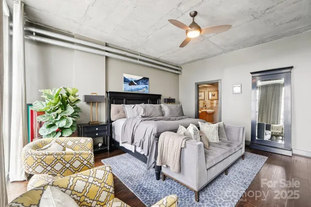 a bed room with a bed mirror and couch