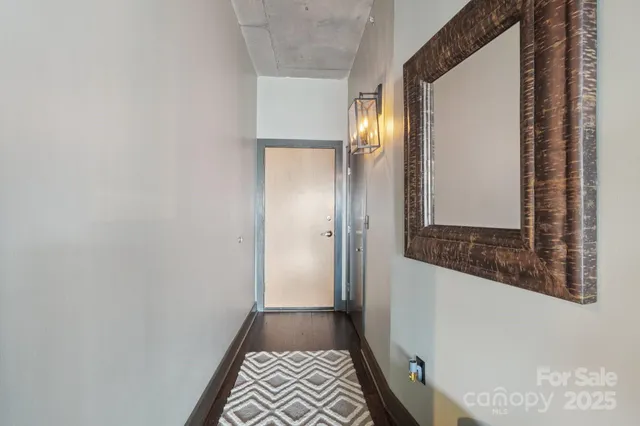 a hallway with wooden floor and windows