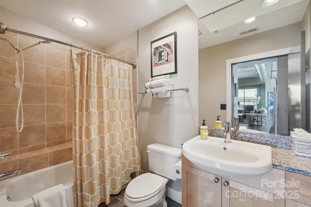a bedroom with bed and a chandelier