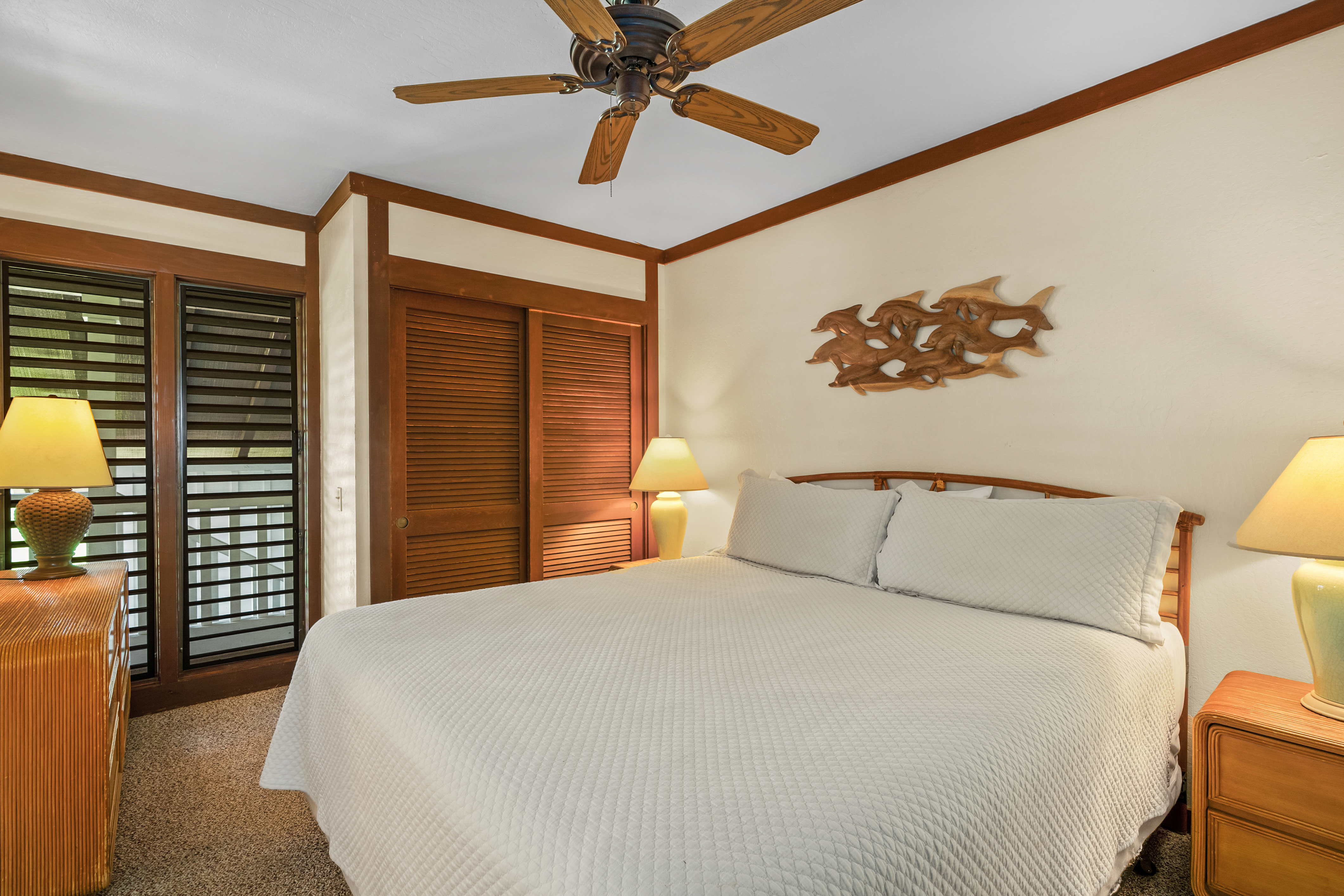 2253 Poipu Road, Unit 67 Koloa, HI 96756 - Photo 11 of 24 a bedroom with a bed and a chandelier