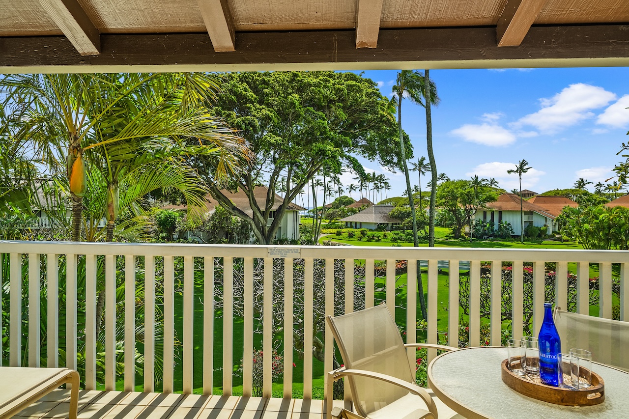 2253 Poipu Road, Unit 67 Koloa, HI 96756 - Photo 16 of 24 a roof deck with table and chairs and wooden floor