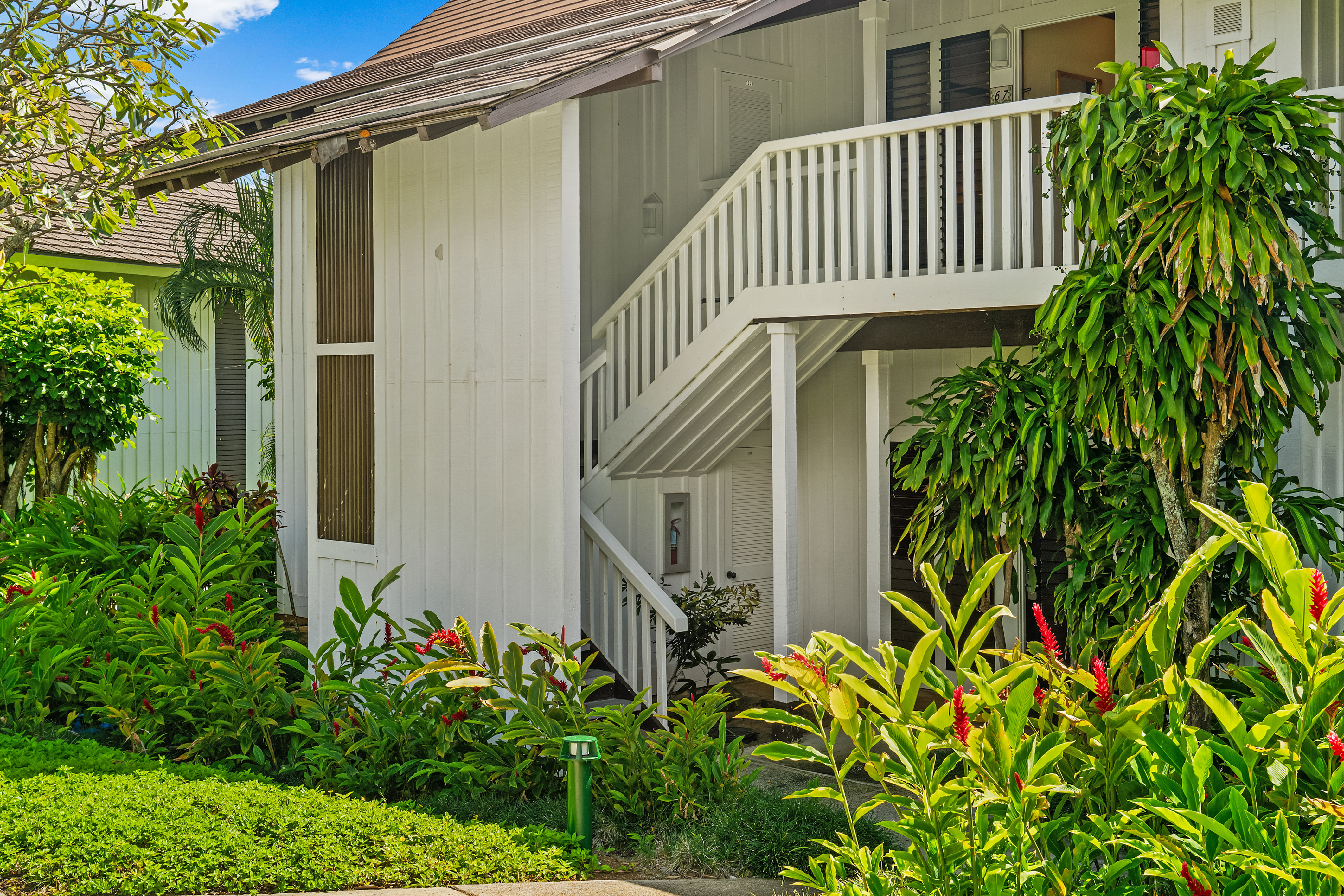 2253 Poipu Road, Unit 67 Koloa, HI 96756 - Photo 18 of 24 a front view of a house with a yard