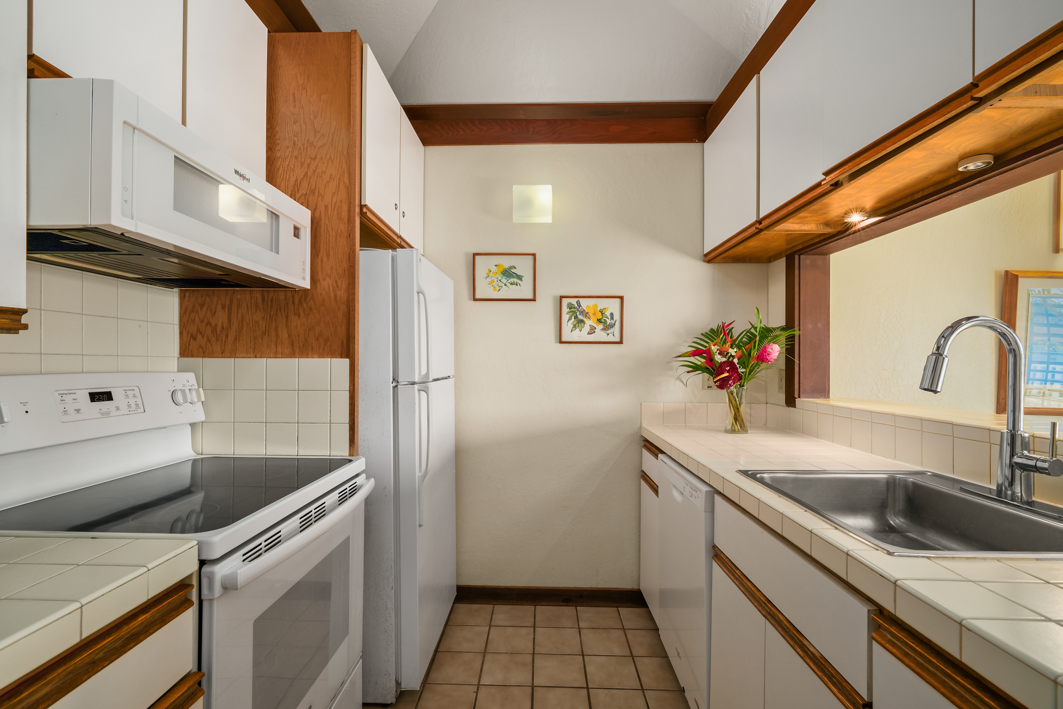 2253 Poipu Road, Unit 67 Koloa, HI 96756 - Photo 5 of 24 a kitchen that has a sink and a stove