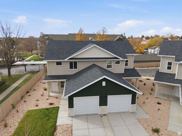 1615 North Angel Street, Unit H Layton, UT 84041 - Photo 41 of 55 Traditional home featuring roof with shingles, stucco siding, a residential view, concrete driveway, and a garage