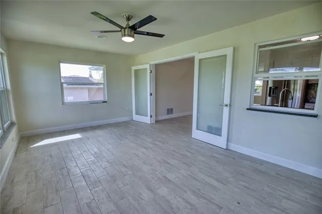 wooden floor in an empty room with a window