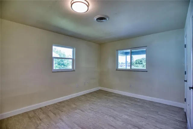 a view of an empty room and wooden floor