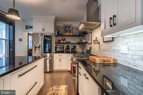a kitchen with stainless steel appliances granite countertop a stove and a refrigerator