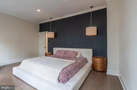 a bedroom with a bed and a night stand