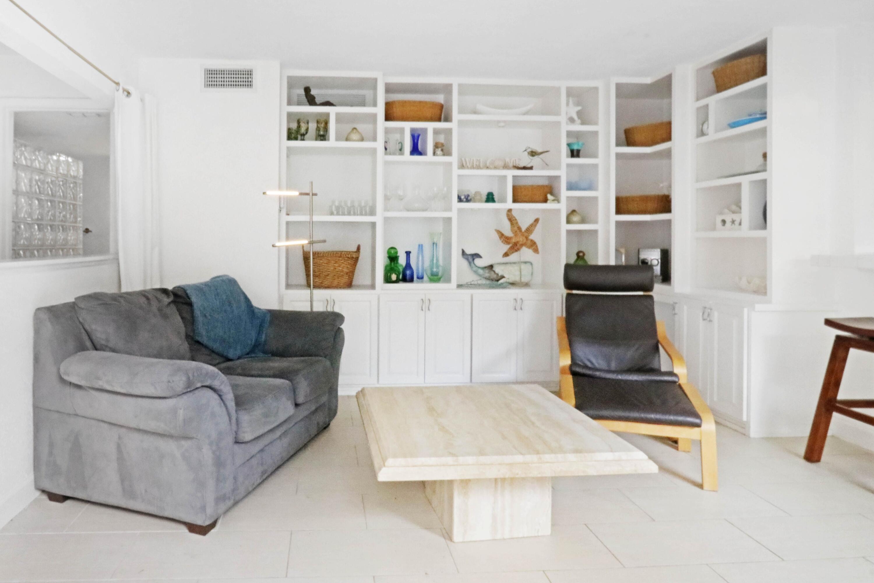 1605 Highway 1, Unit 4B Jupiter, FL 33477 - Photo 6 of 26 a living room with furniture and a book shelf