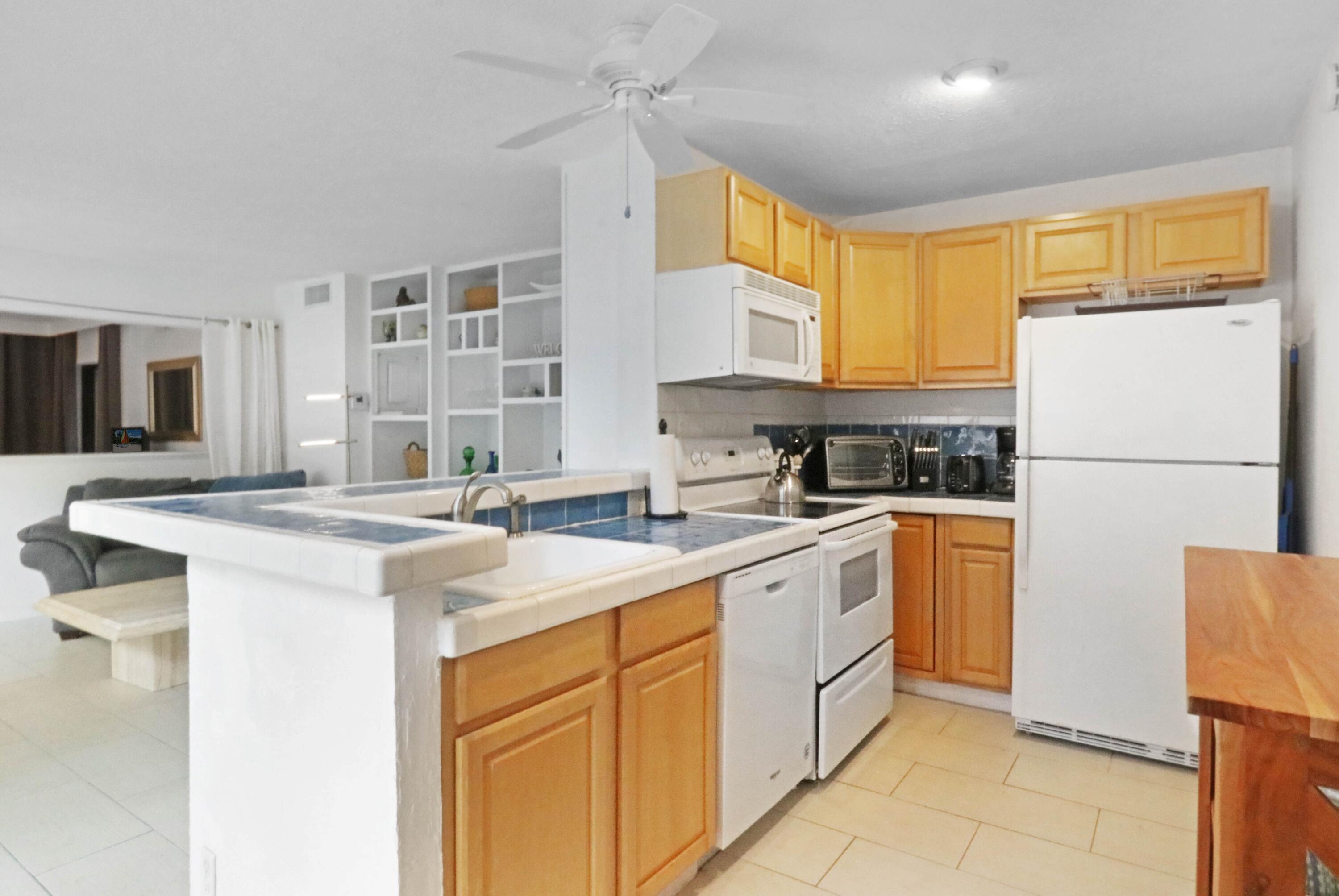 1605 Highway 1, Unit 4B Jupiter, FL 33477 - Photo 9 of 26 a kitchen with a sink stove and refrigerator