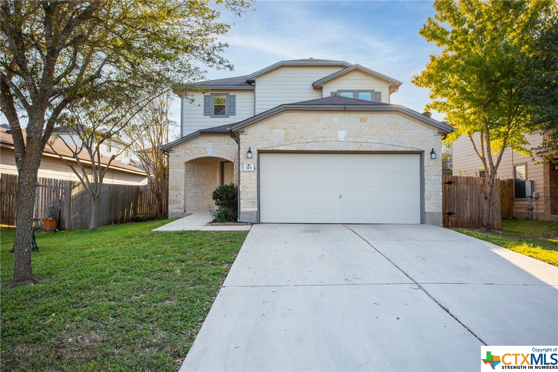 215 Myrtle Street Kyle, TX 78640 - Photo 1 of 1 a front view of a house with a yard and trees