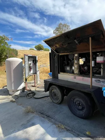 a view of a chairs and table in backyard