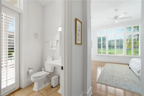 a bathroom with a toilet sink and a mirror