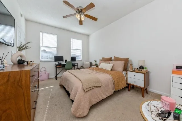 a spacious bedroom with a bed and window