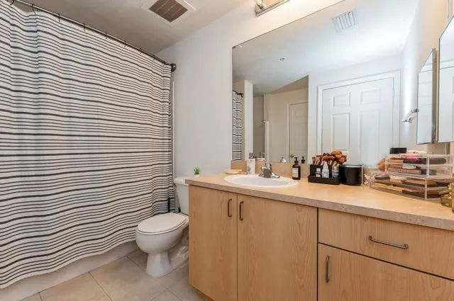 a bathroom with a toilet a sink and mirror