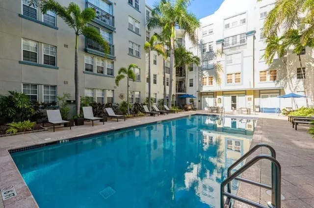 a swimming pool with outdoor seating and yard