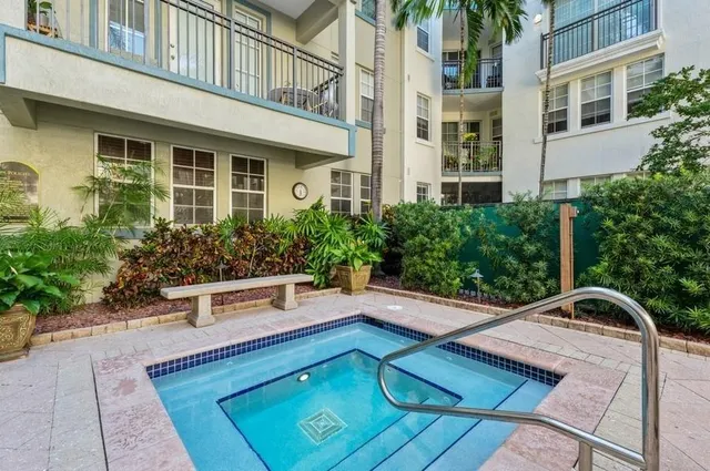 a view of a patio with couches table and chairs and potted plants