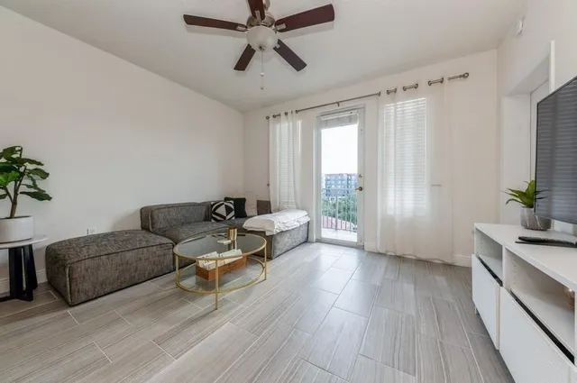 a living room with furniture and a large window