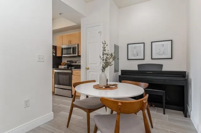 a dining room with furniture and wooden floor