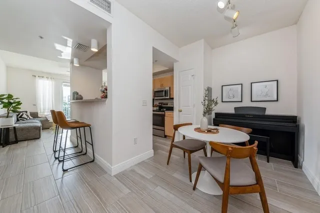 a view of a dining room with furniture and wooden floor