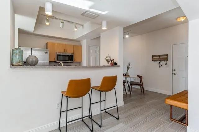 a view of a livingroom with furniture and a flat screen tv