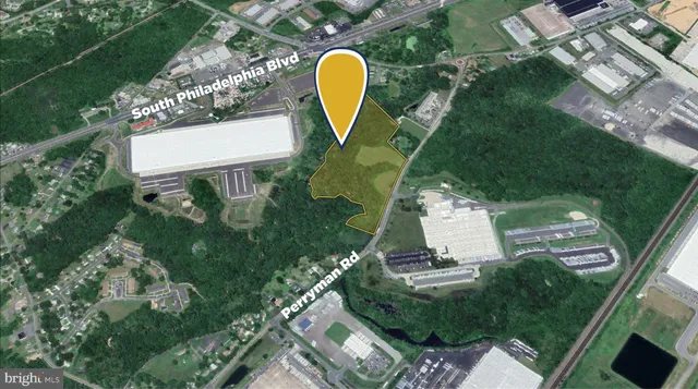 an aerial view of a swimming pool with a yard and plants