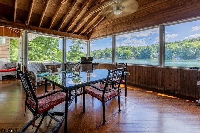 a dining room with furniture window and wooden floor