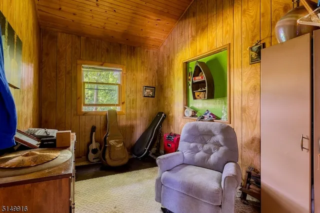 a living room with furniture a flat screen tv and a window