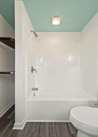a bathroom with a toilet and a shower