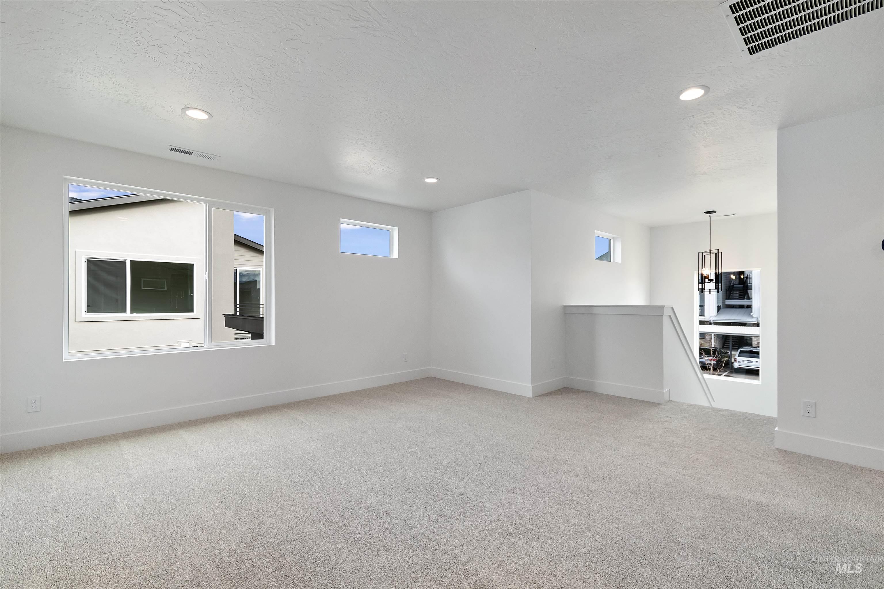 764 South Calhoun Lane Star, ID 83669 - Photo 27 of 48 Unfurnished room featuring light carpet, recessed lighting, and a textured ceiling