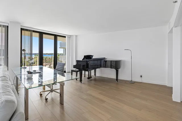 a living room with furniture and a floor to ceiling window