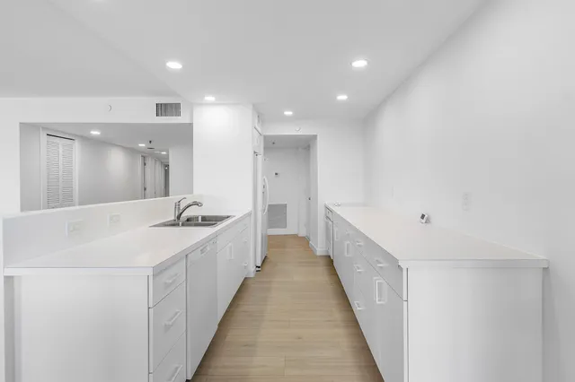 a bathroom with a double vanity sink and a bathtub