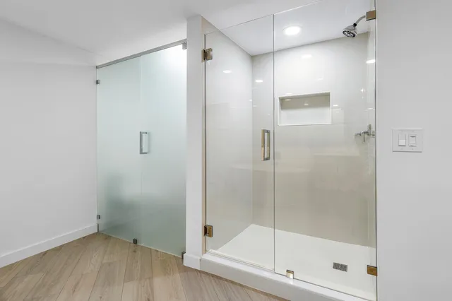 a bathroom with a glass shower door