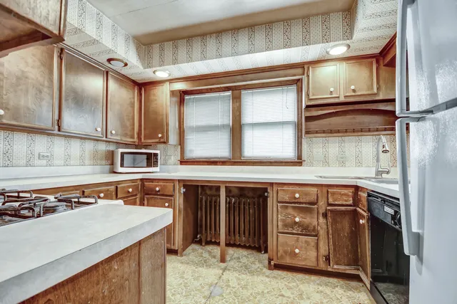 a kitchen with stainless steel appliances granite countertop a sink and a stove