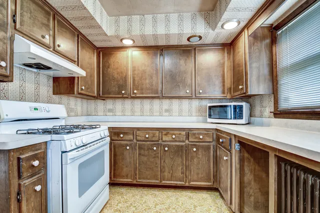 a kitchen with a sink cabinets and appliances