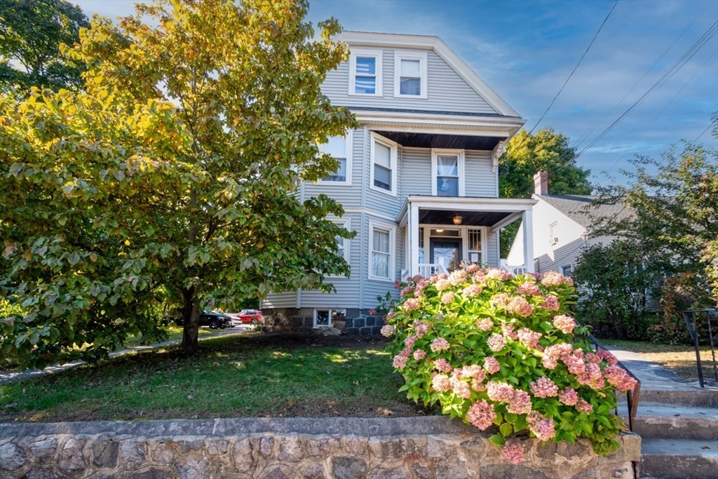 a front view of a house with garden