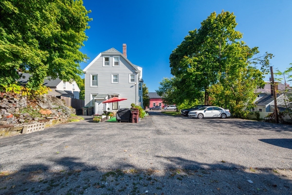 69 Milton Street Dedham, MA 02026 - Photo 23 of 33 a view of a small house with a car parked in front of it