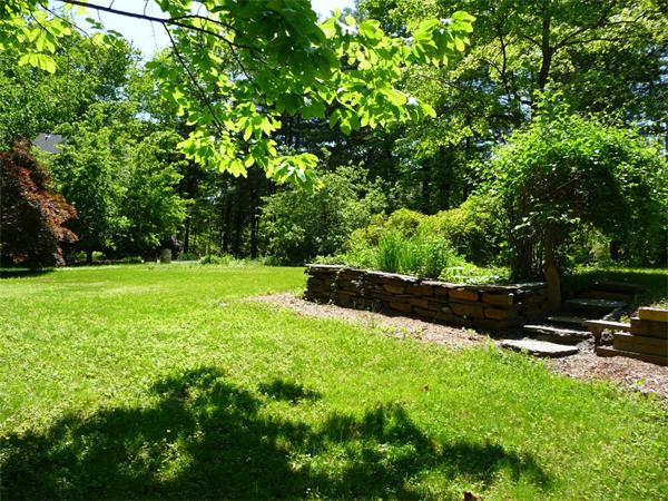 408 Florence Road Northampton, MA 01062 - Photo 4 of 30 a view of a garden with a bench
