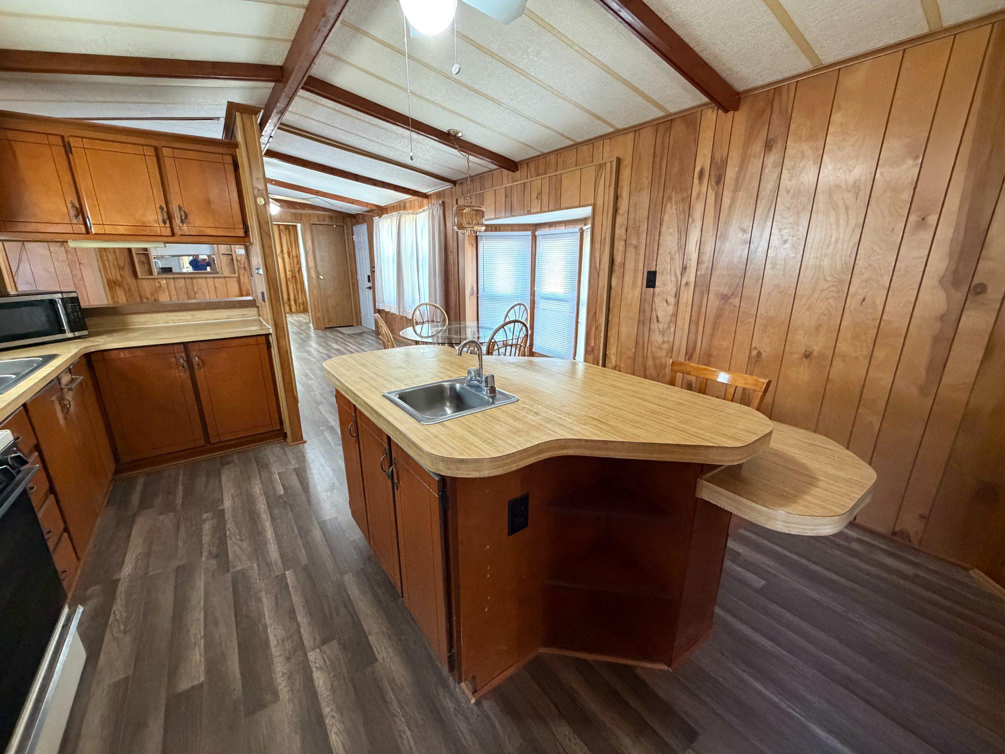 417 Captain Smith Lane Buena, NJ 08310 - Photo 12 of 25 a kitchen with a sink and wooden cabinets