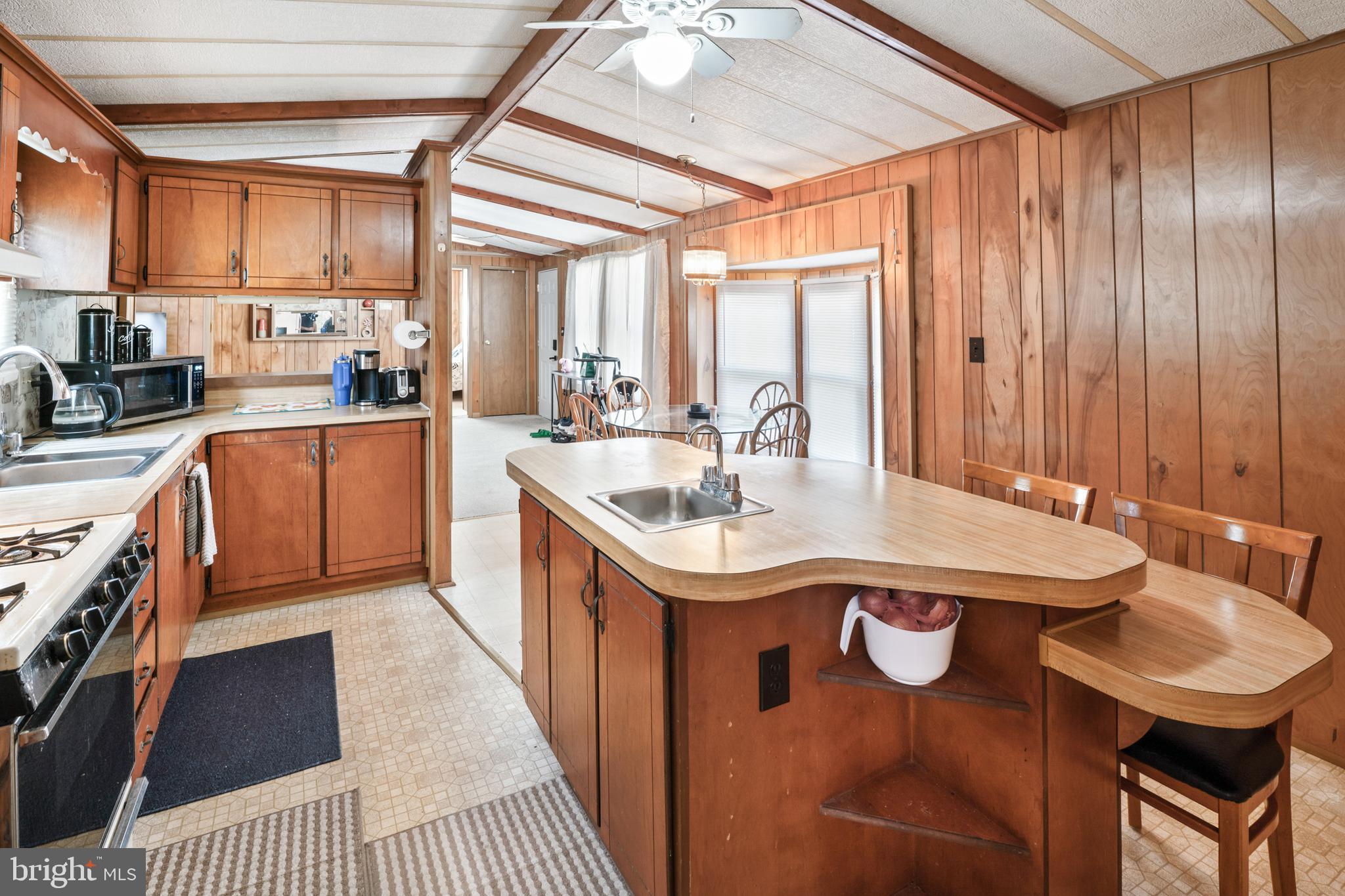 417 Captain Smith Lane Buena, NJ 08310 - Photo 16 of 31 a kitchen with a stove a sink and a refrigerator
