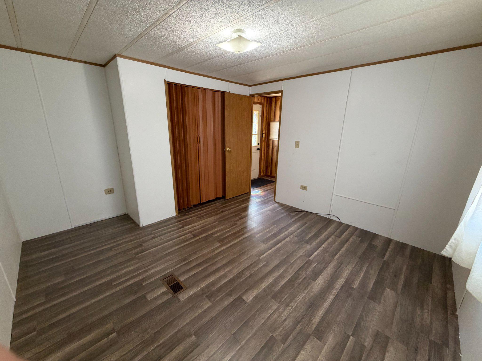 417 Captain Smith Lane Buena, NJ 08310 - Photo 18 of 25 a view of an empty room with wooden floor