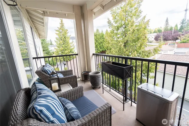 a balcony with furniture and a potted plant