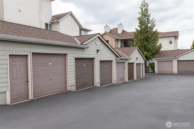 a view of a house with a garage and balcony