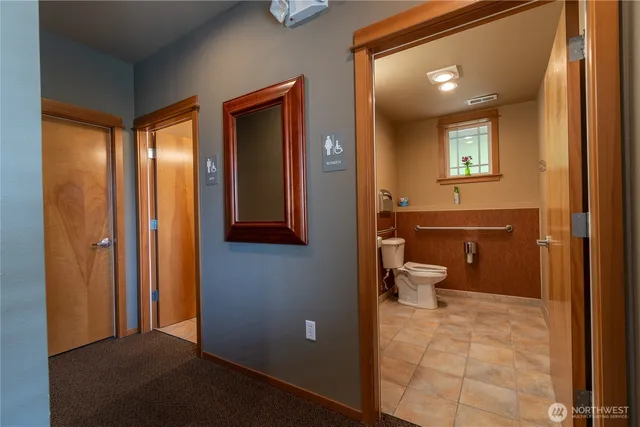 a bathroom with a toilet sink and mirror