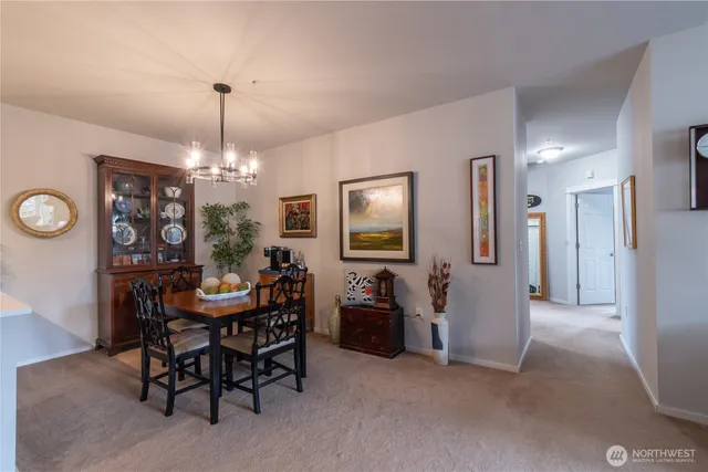 a view of a dining room with furniture and chandelier