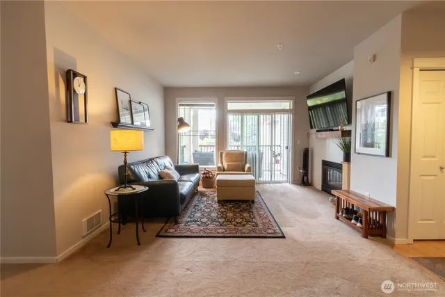 a living room with fireplace furniture and a window