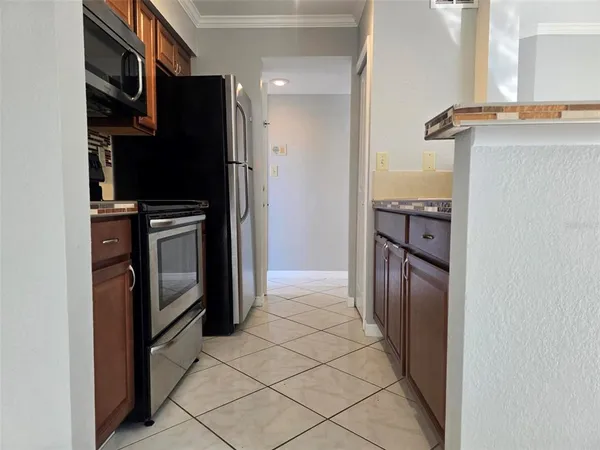 a kitchen with granite countertop a sink stove and cabinets