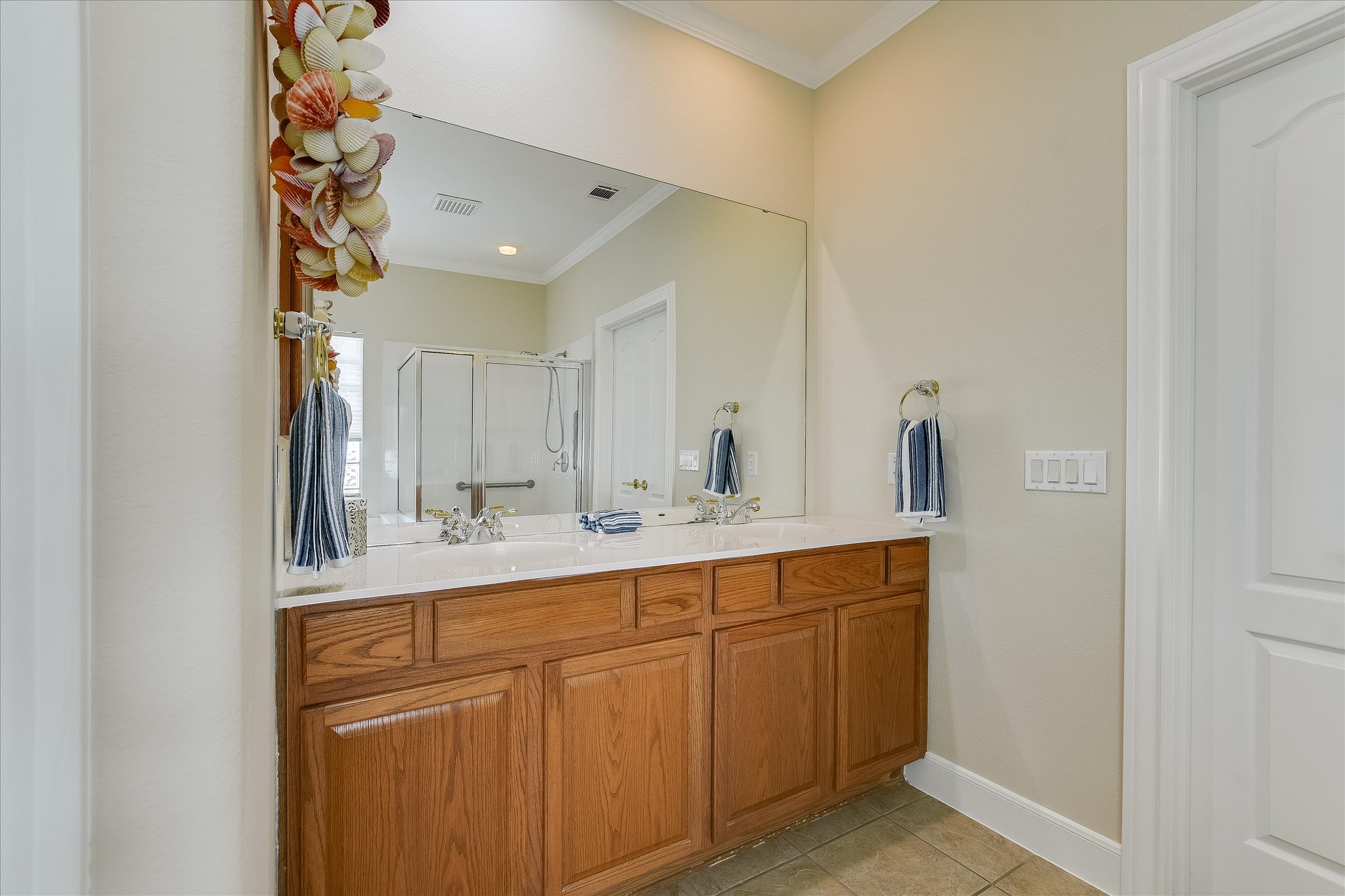603 Rio Grande Loop Georgetown, TX 78633 - Photo 16 of 27 Full bath with crown molding, a stall shower, light tile patterned flooring, and double vanity