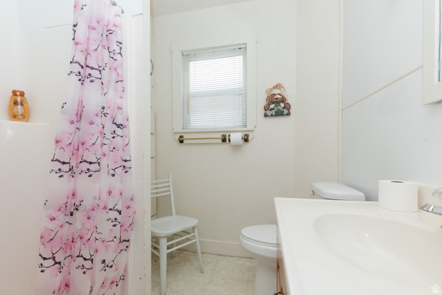 6746 North Capitol Hill Road Preston, ID 83263 - Photo 11 of 18 Bathroom featuring a single vanity, built-in tub with shower, and window with blinds